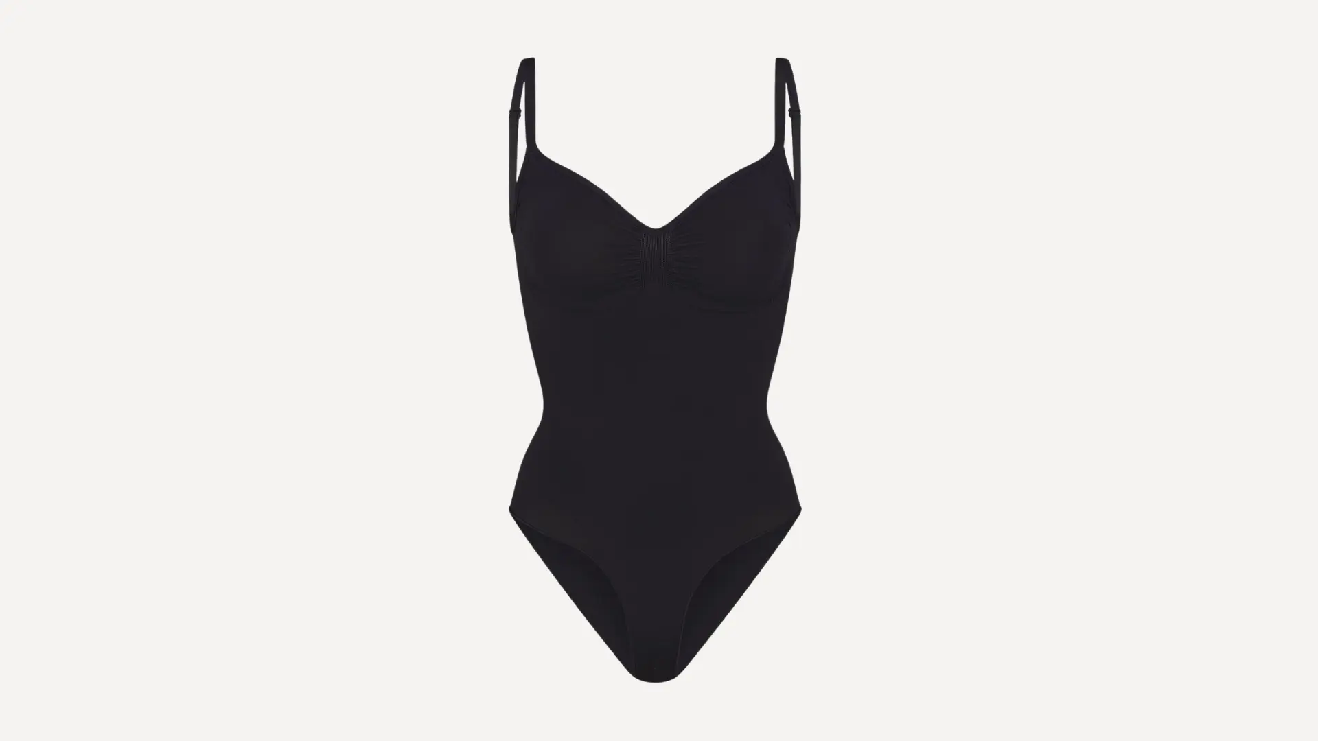 black bodysuit featuring thin adjustable spaghetti straps and a ruched sweetheart neckline on a plain white background