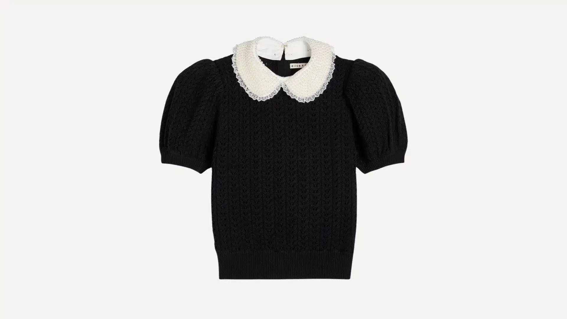 black short-sleeved cable knit peter pan collar top with white pearl and lace embellishments on a plain background