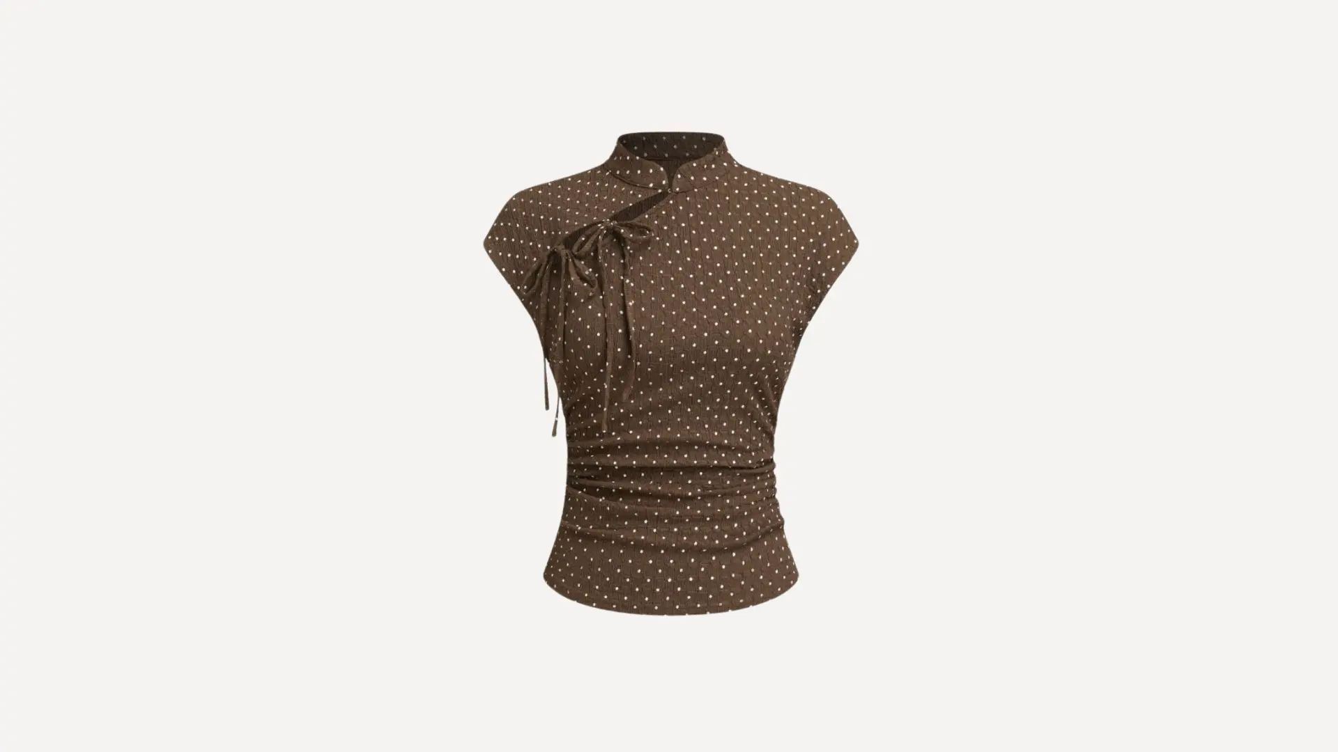 brown polka dot mock neck _ half turtleneck top with cap sleeves and a side tie detail on a white background