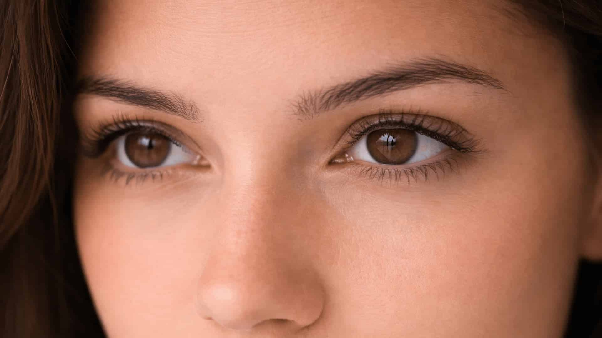 close-up of deep-set brown eyes under defined brow bone with soft natural lighting and visible skin texture