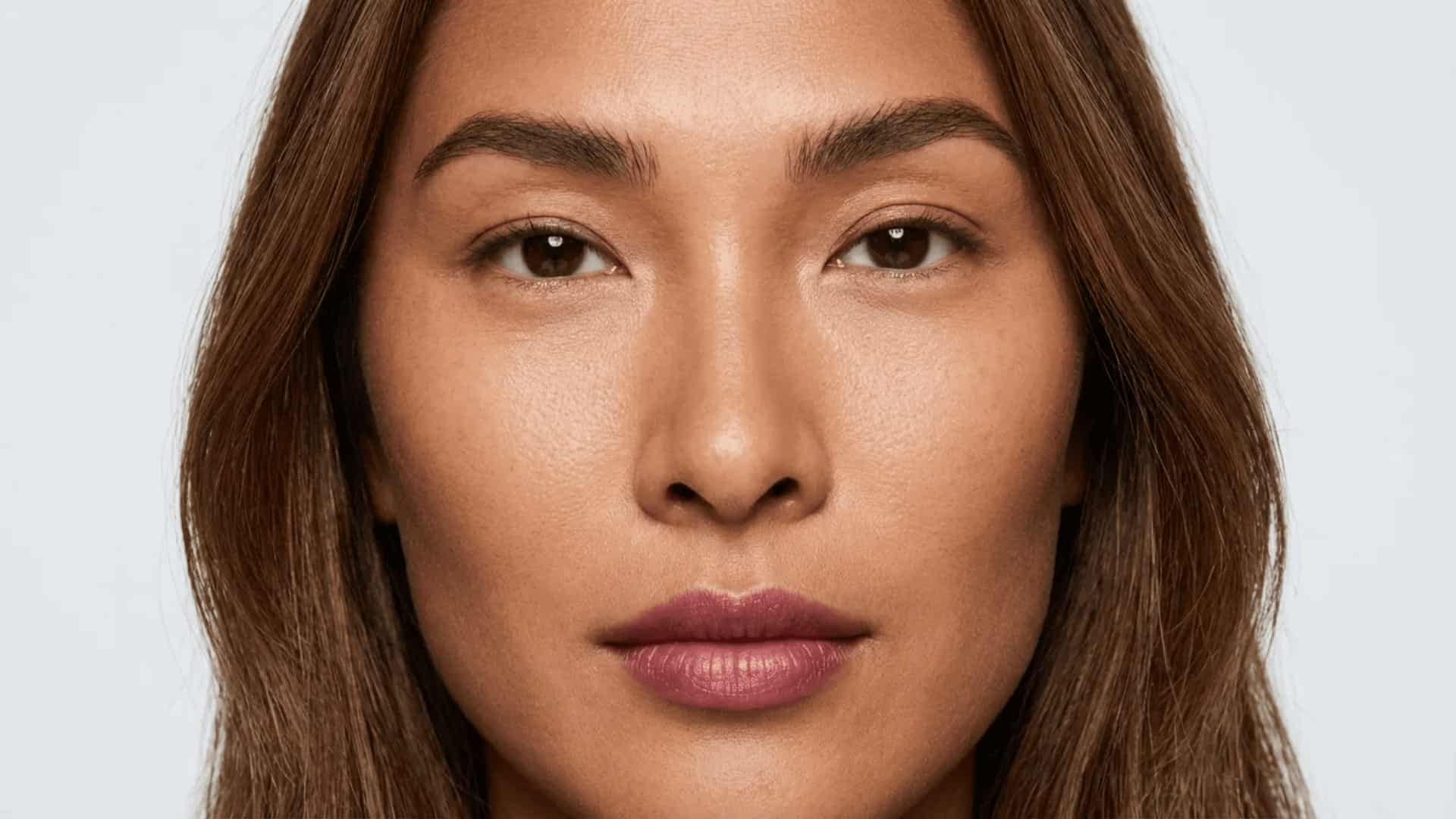 close-up portrait of a woman with monolid eyes, neutral expression, and soft natural lighting