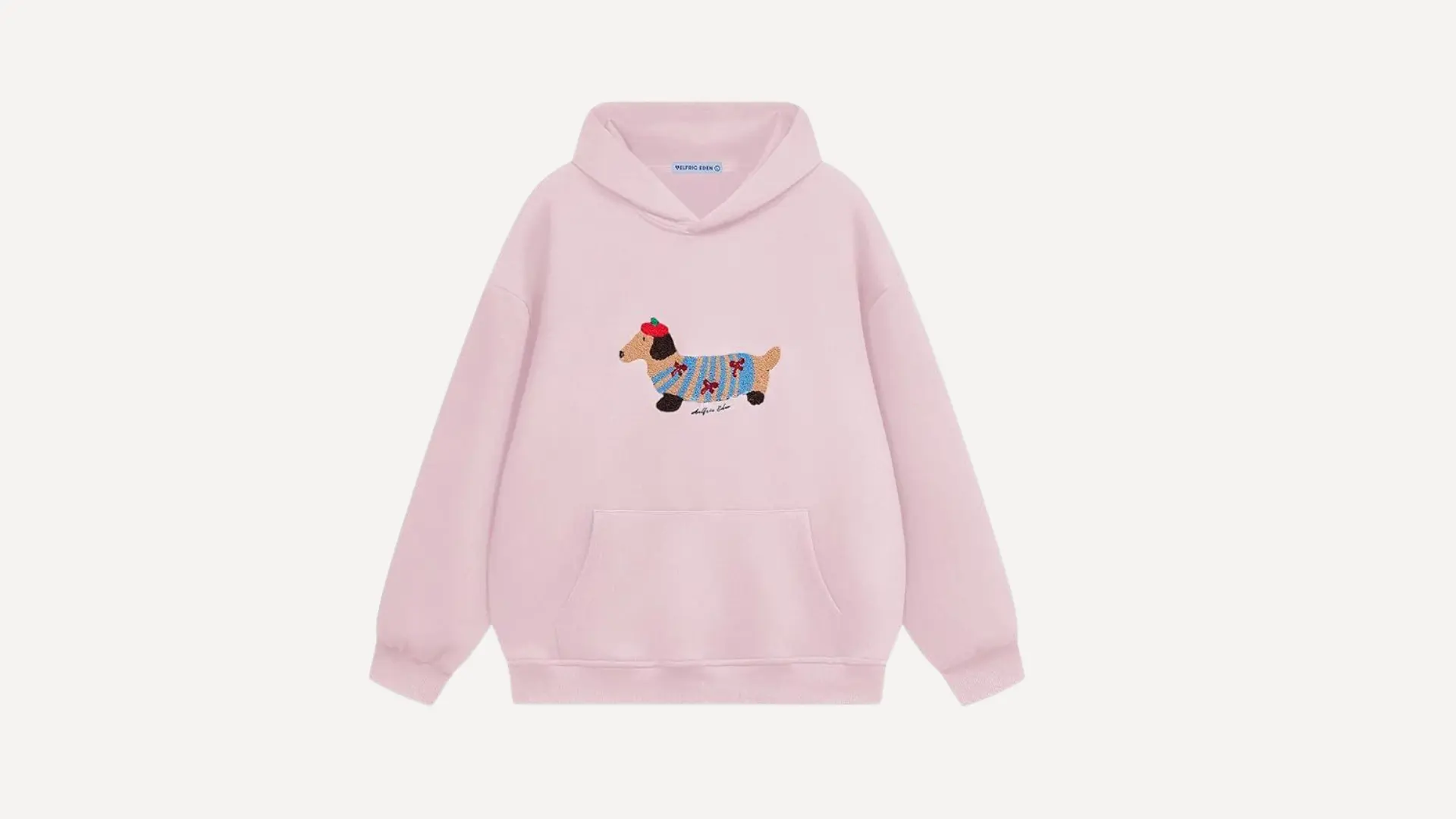 light pink hoodie with a front pouch pocket and a cute dachshund graphic wearing a sweater on a white background