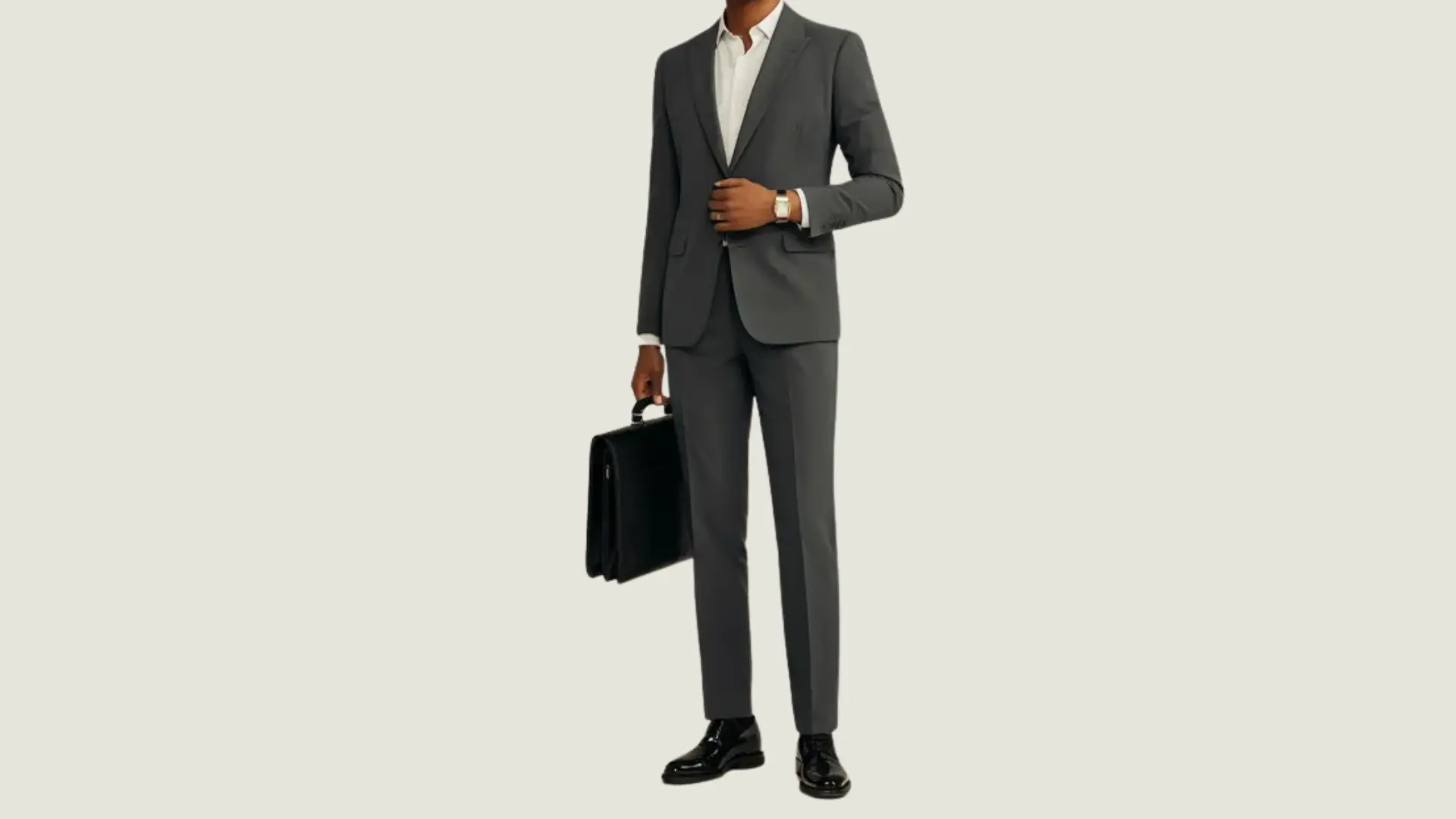 man in business_formal style wearing a charcoal suit and white shirt holding a black briefcase