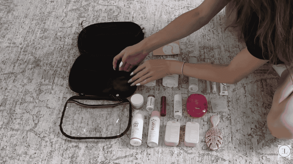 packing toiletries and personal care items into a travel pouch for how to pack a suitcase efficiently