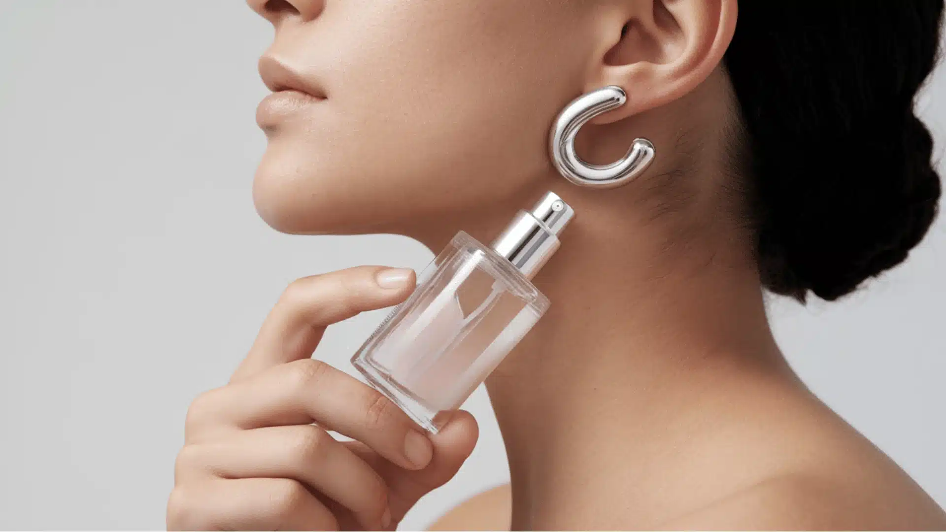 she is holding a transparent bottle labeled 'clinique happy' with a silver spray nozzle