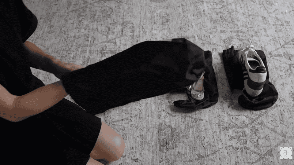 shoes and accessories prepared in protective bags as part of how to pack a suitcase efficiently