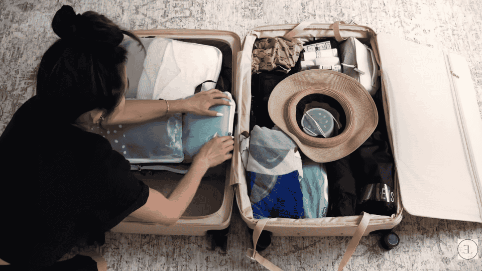traveler arranging packing cubes neatly on the flat side while learning how to pack a suitcase efficiently