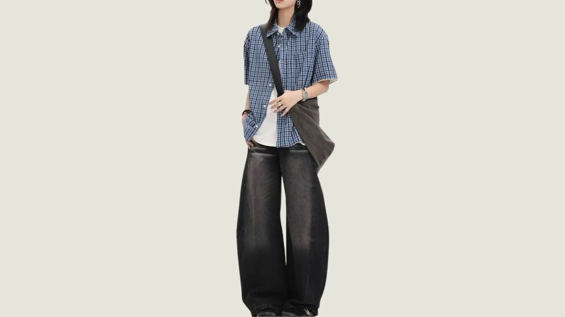 woman in tomboy style wearing an oversized striped rugby shirt with loose khaki trousers and white sneakers