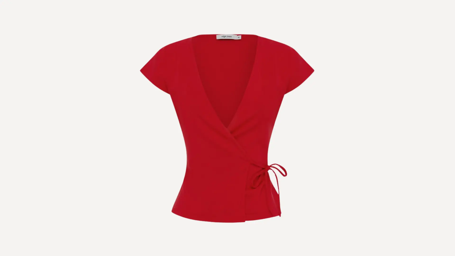 bright red short-sleeve wrap top with a deep v-neckline and a delicate side-tie closure on a plain white background