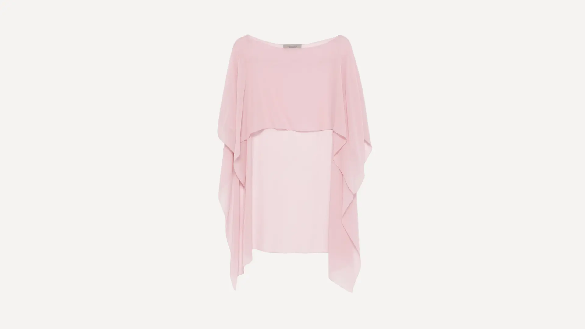 cream-colored poncho top with an intricate paisley pattern and a loose draped fit on a white background