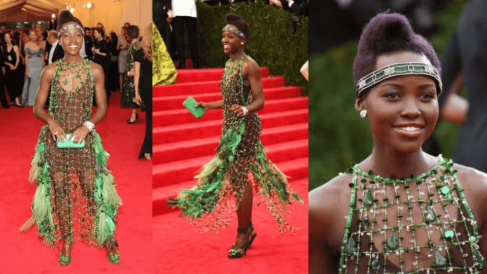 lupita nyongo in emerald green beaded prada net dress with feathers at the 2014 met gala charles james beyond fashion theme