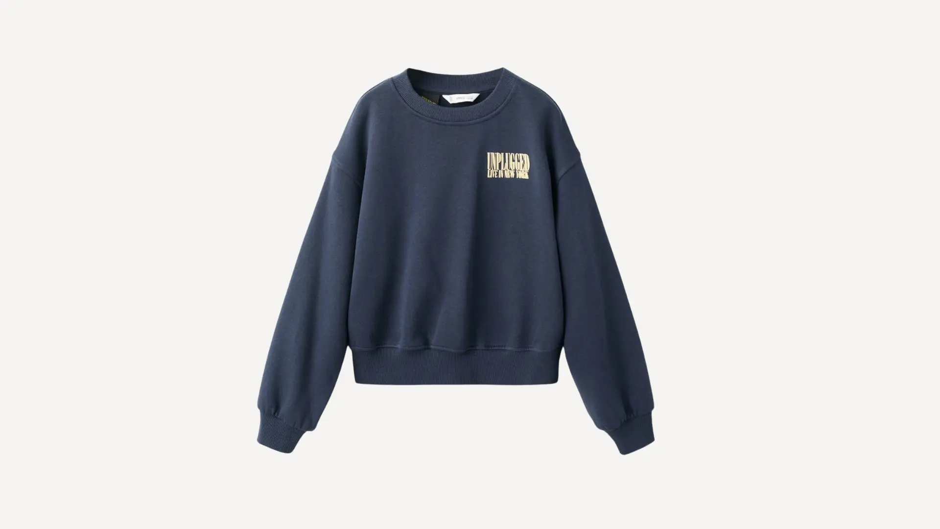 navy blue crewneck sweatshirt featuring a small graphic on the chest with long cuffed sleeves on a plain background