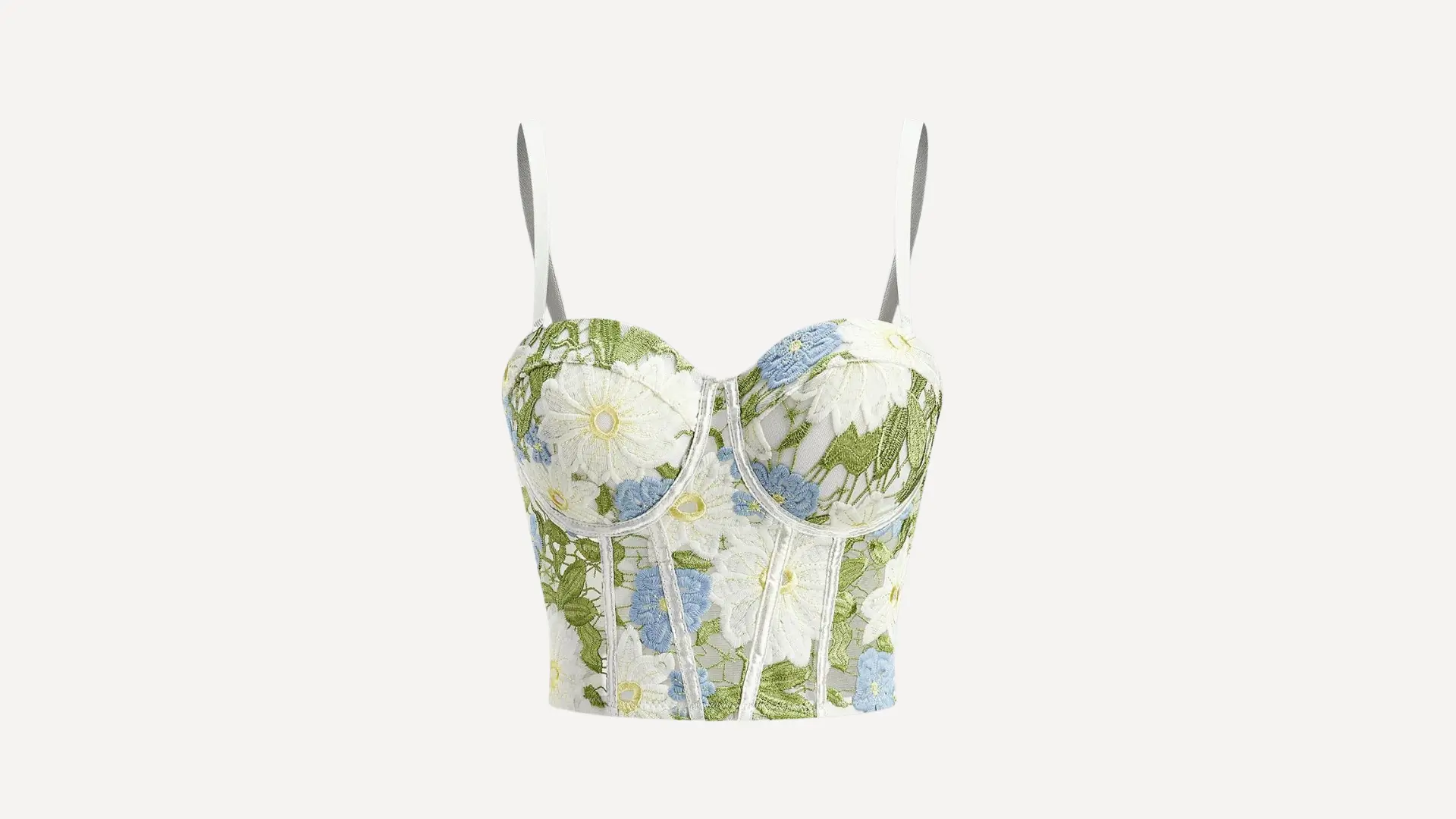 white bustier top with thin straps and blue, yellow, and green floral embroidery on a plain background