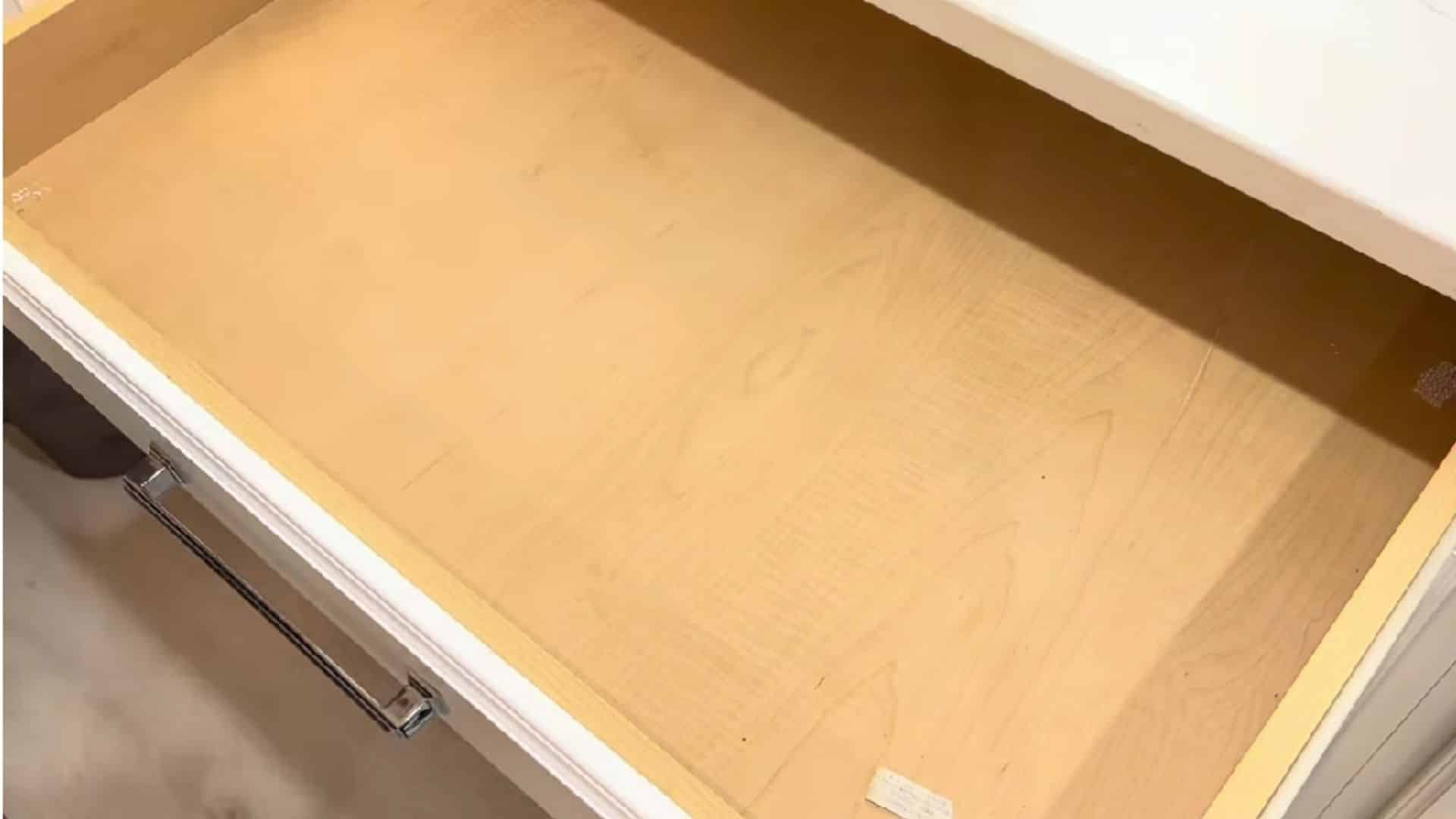 Decluttering and cleaning kitchen drawers to remove dust, crumbs and unwanted items