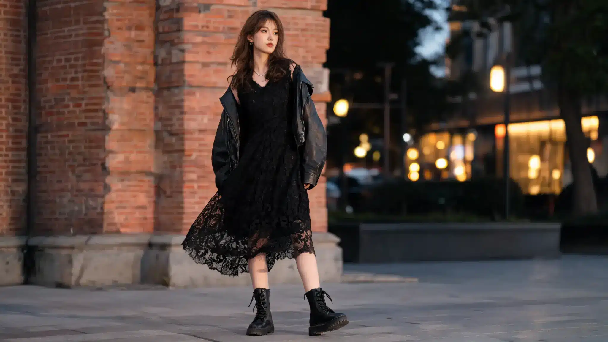 Woman in black lace dress with chunky combat boots outdoors