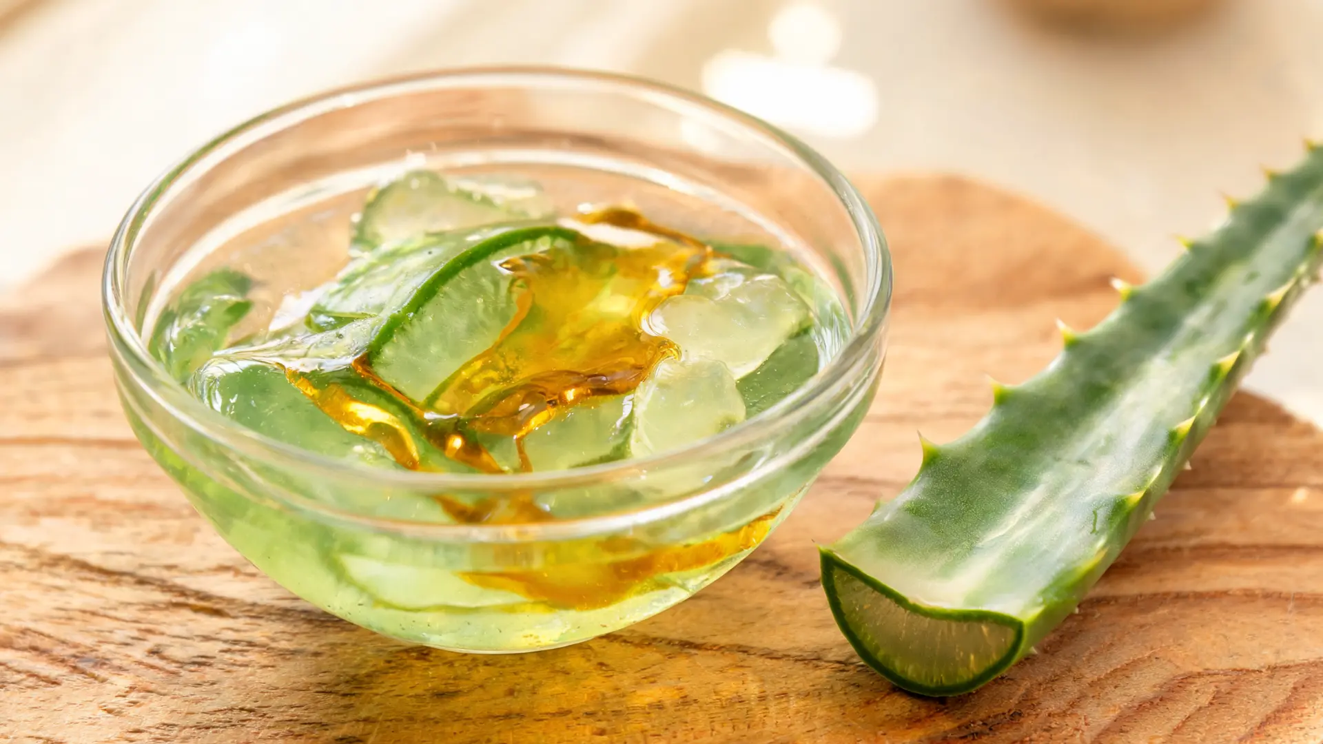 aloe vera castor oil blend in bowl thick texture wooden spa table natural light