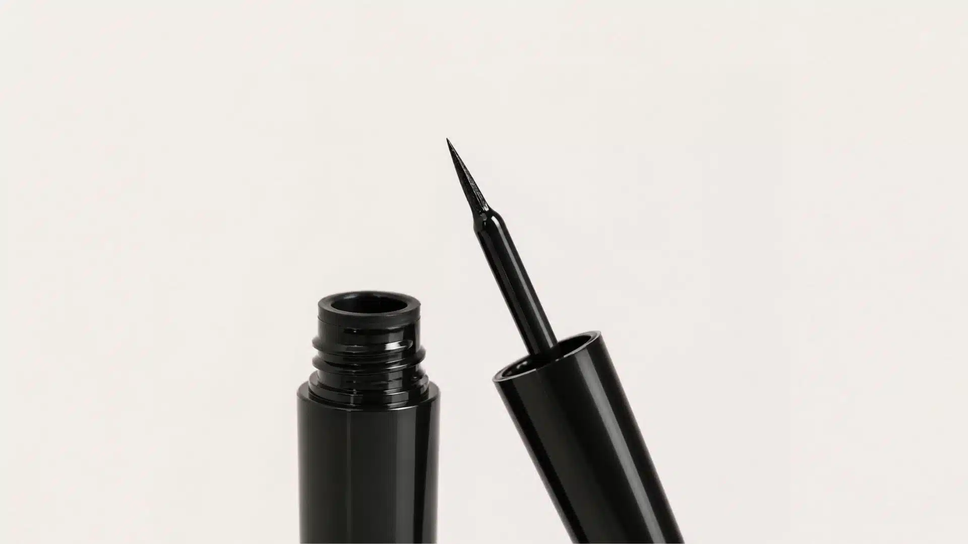 black liquid eyeliner tube with fine applicator
