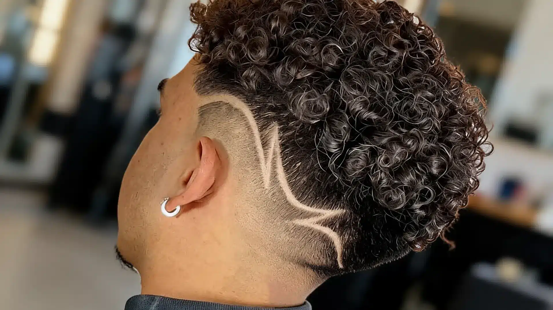 boys haircut with design featuring a short zigzag pattern shaved into a clean side fade