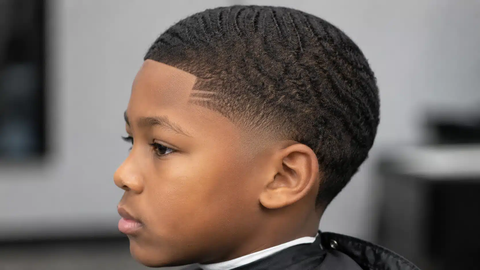 boys haircut with design featuring a small temple fade line near the front hairline