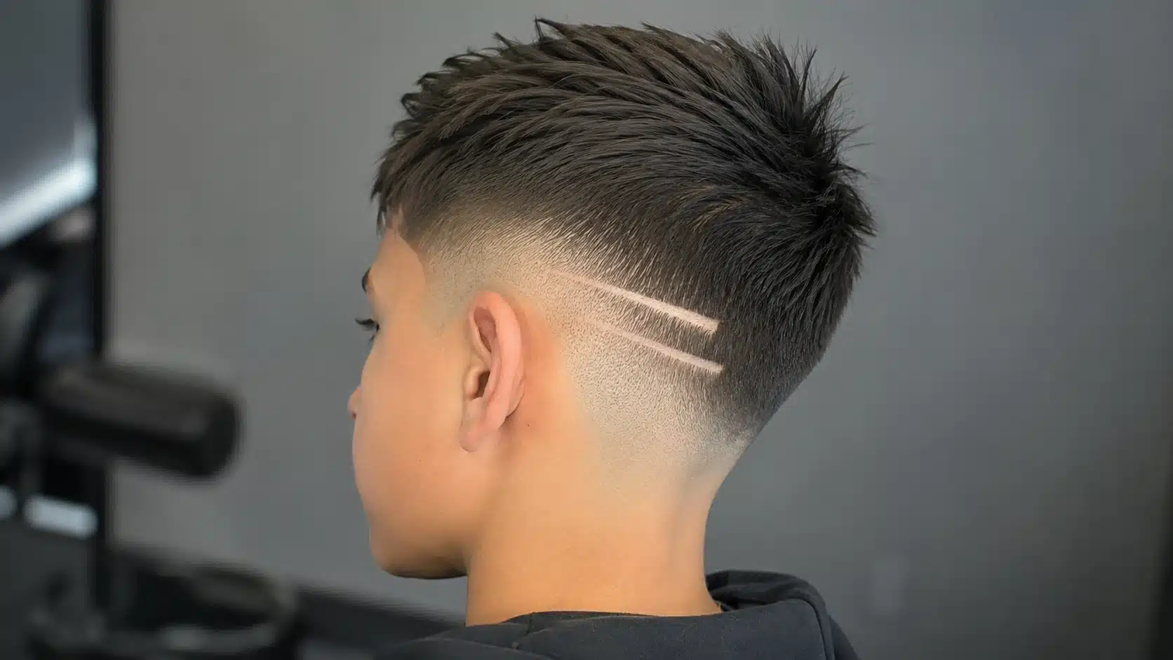 boys haircut with design showing a low fade with a small side line for a subtle and school friendly look