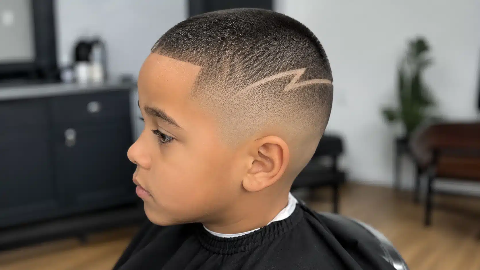 boys haircut with design showing a short buzz cut with one clear shaved pattern