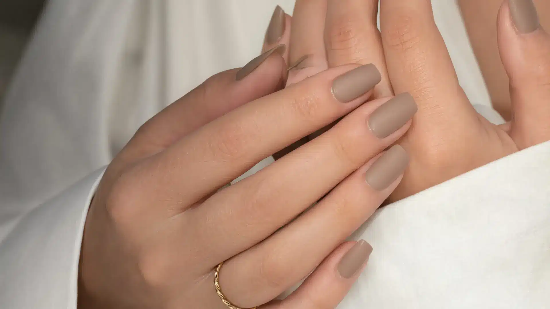 close up matte nails square soft velvet finish neutral tones modern minimal fashion editorial lighting