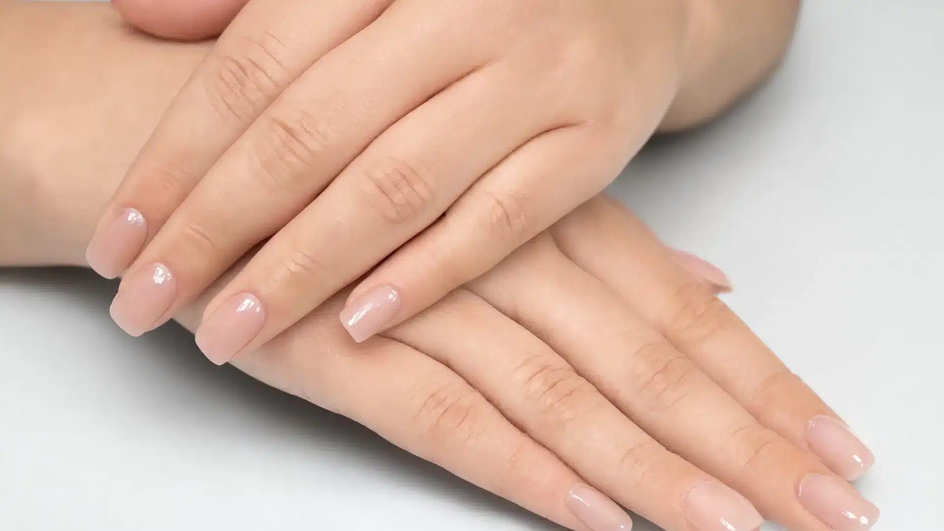 close up minimal short nails round square oval shapes natural reinforced nails clean nude finish everyday professional look