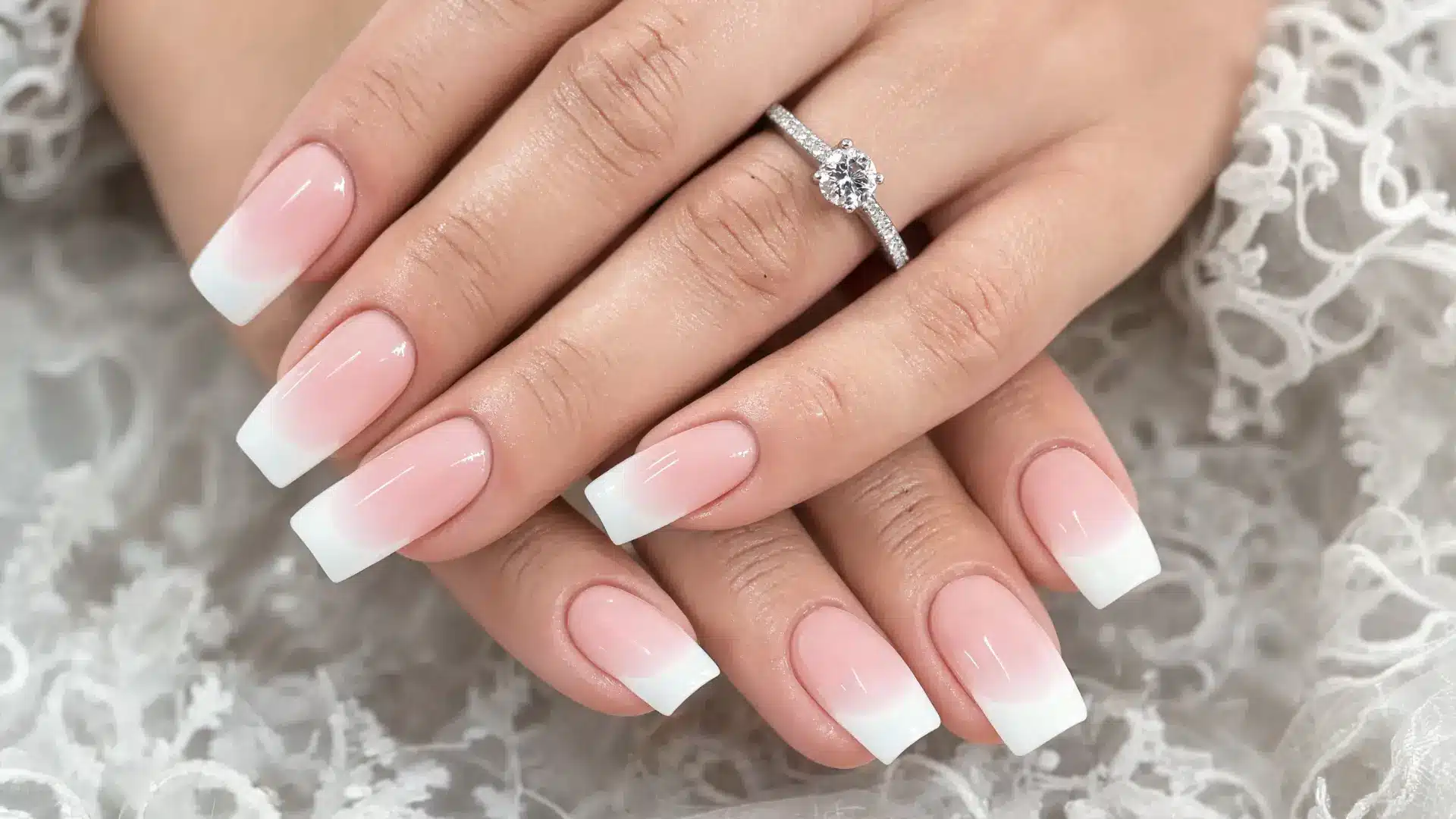 close up ombre fade nails pink to white gradient coffin almond shapes glossy gel finish wedding aesthetic soft light