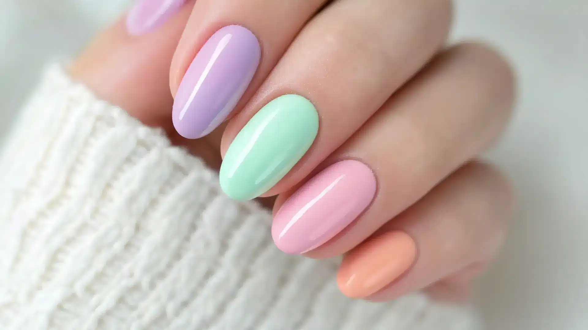 close up pastel nails lavender mint baby pink peach tones almond oval shapes soft gel finish spring aesthetic soft light