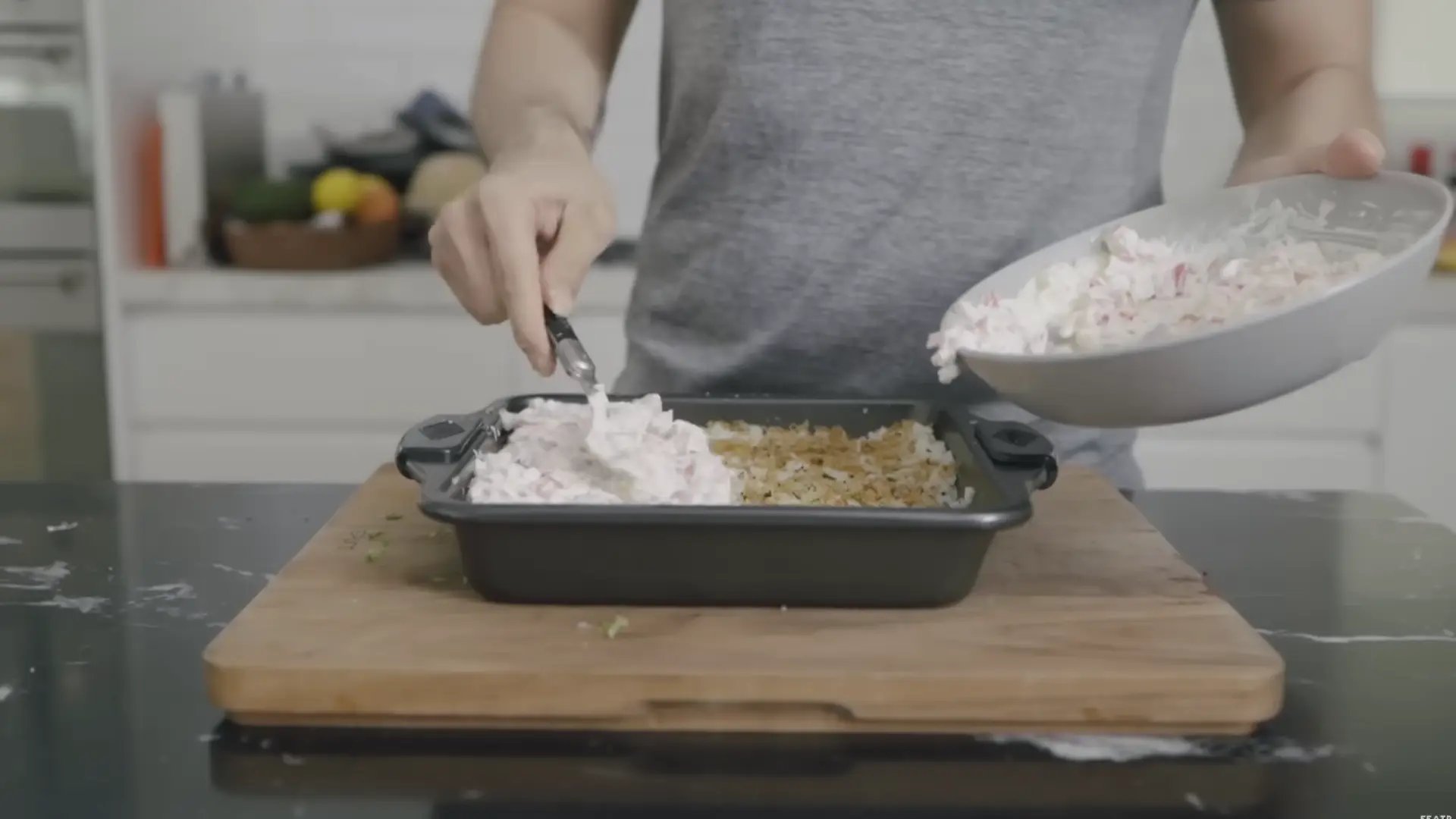 creamy crab mixture spread evenly over seasoned rice layer in a baking dish for