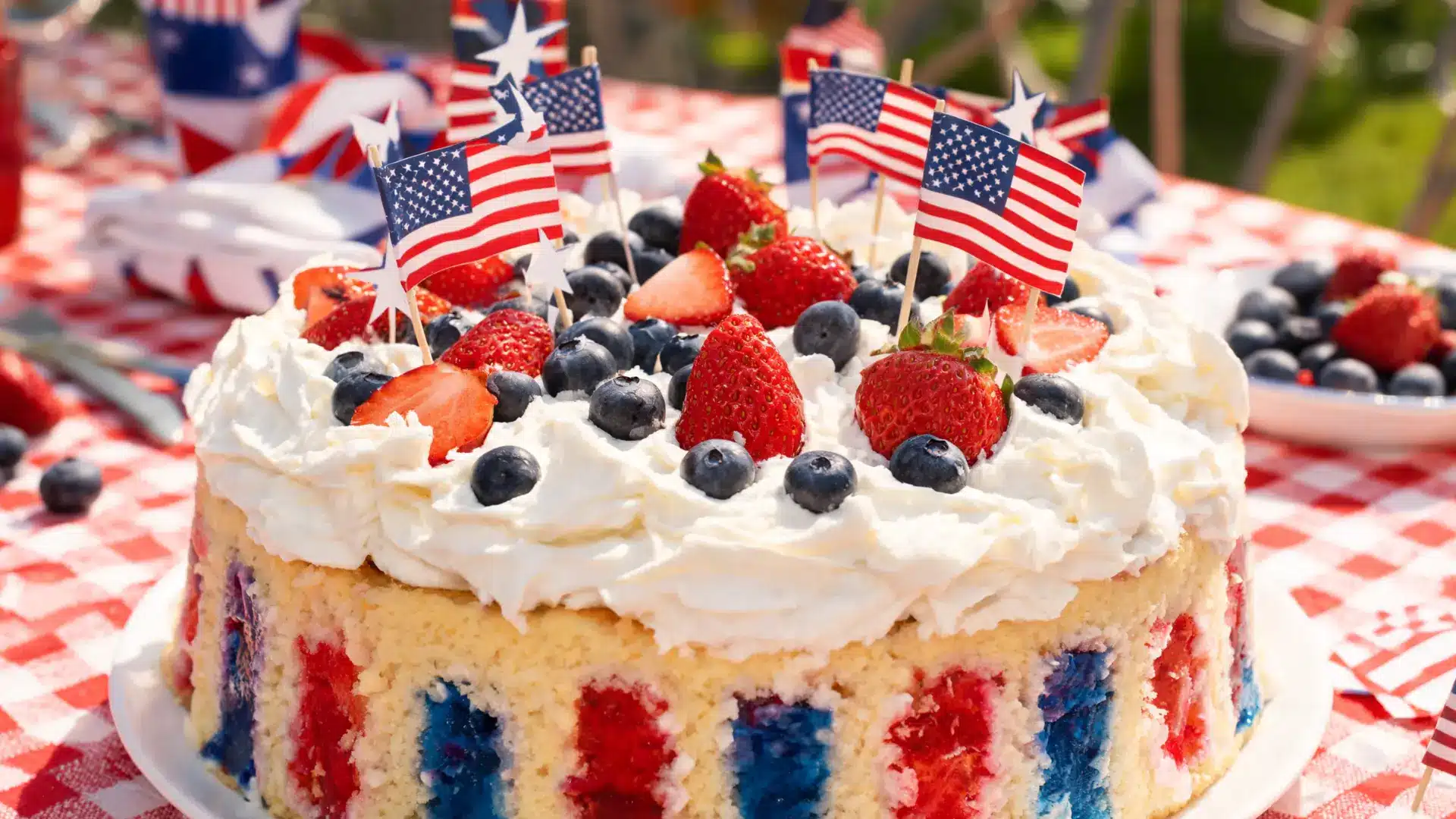 flag poke cake with gelatin stripes whipped cream and berries on top