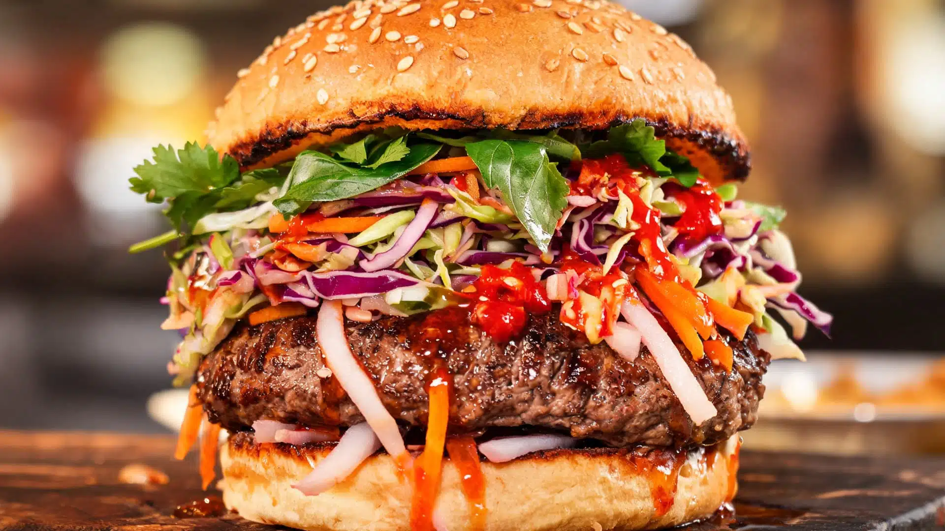fusion style burger with beef patty topped with colorful cabbage slaw herbs and spicy sauce on toasted bun close up realistic texture and vibrant colors