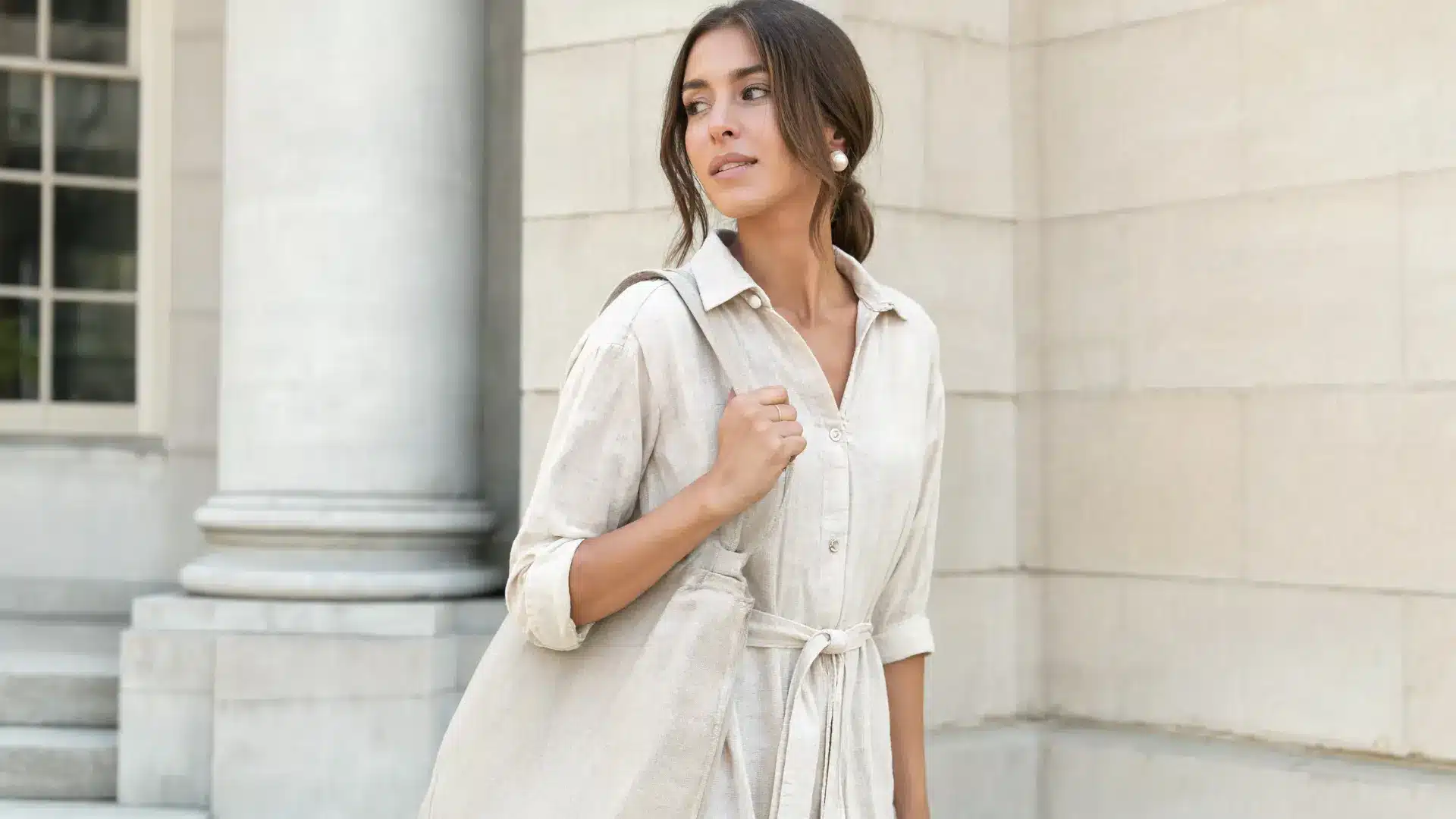 light academia fashion photo of American woman in cream linen dress with pearl earrings and soft tones