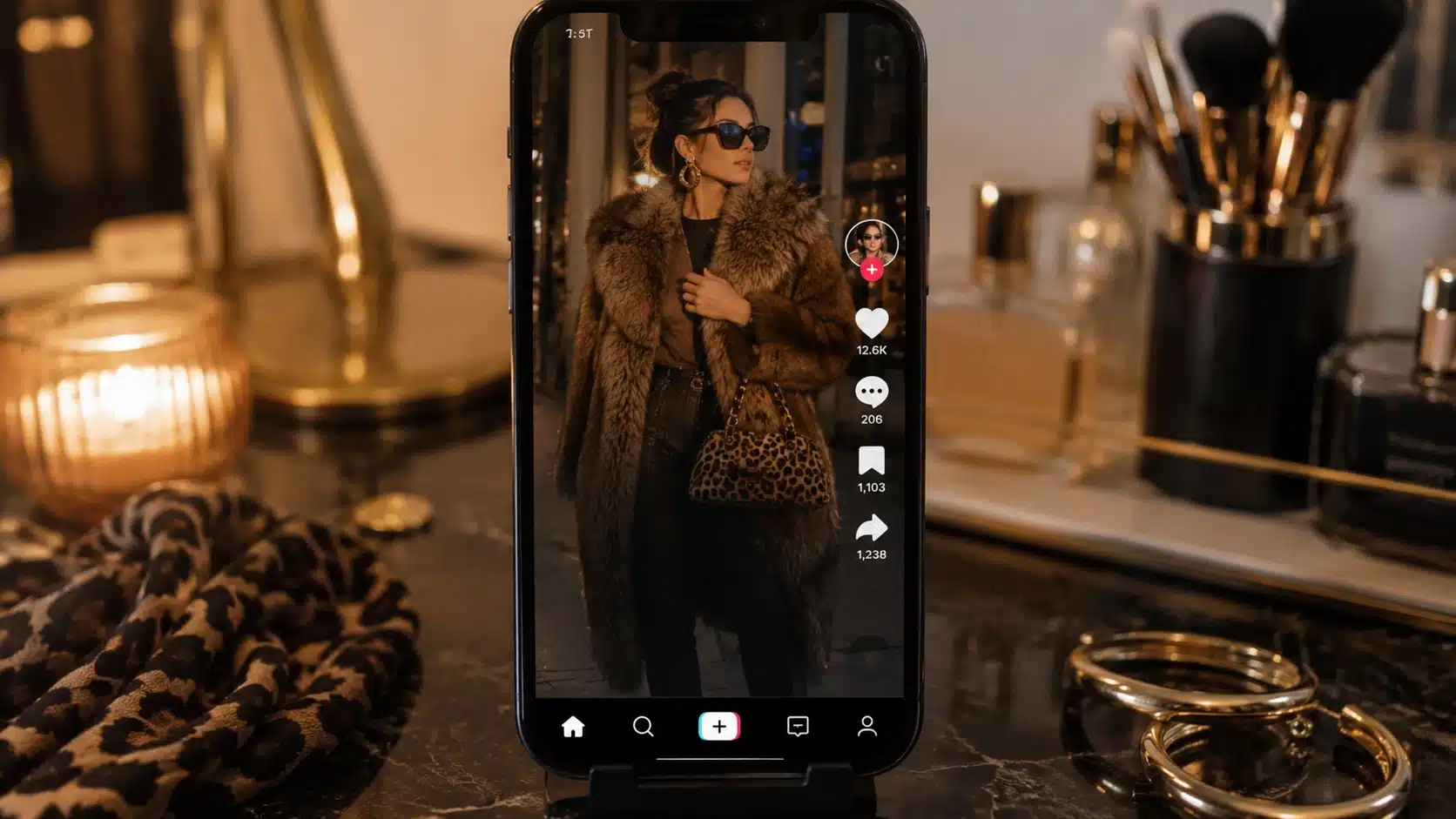 mob wife aesthetic video on phone with faux fur outfit, leopard bag, gold hoops, and vanity setup