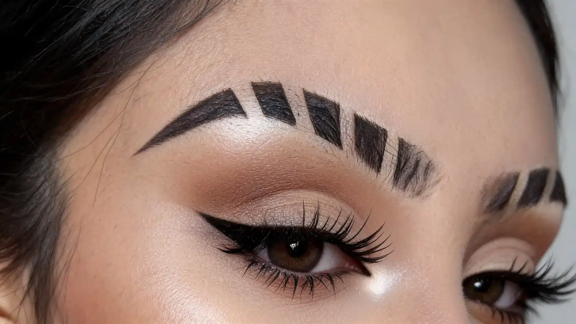 multiple eyebrow slits with three clean shaved lines on a thick brow creating a bold stylish statement look