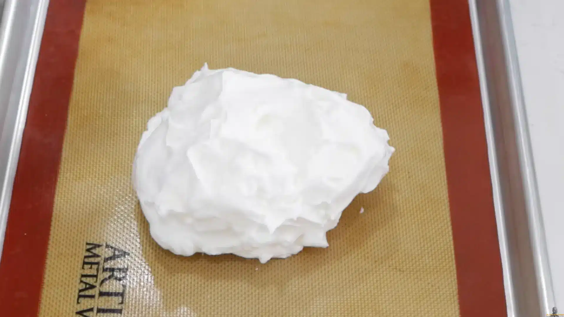 scooping whipped meringue mixture onto tray and shaping into soft cloud-like dome