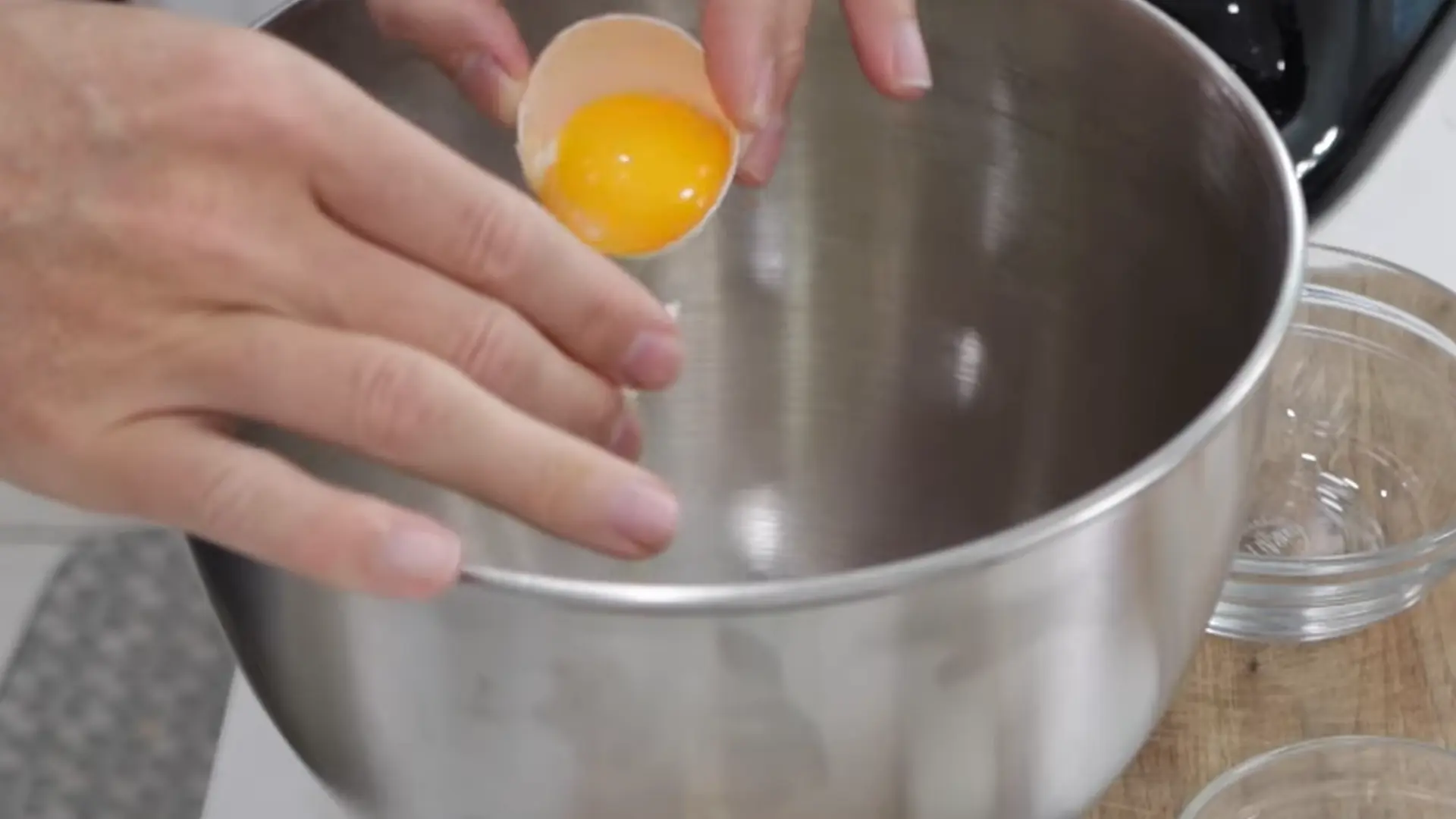 Separating egg whites from yolks carefully in clean bowls to prepare cloud bread mixture