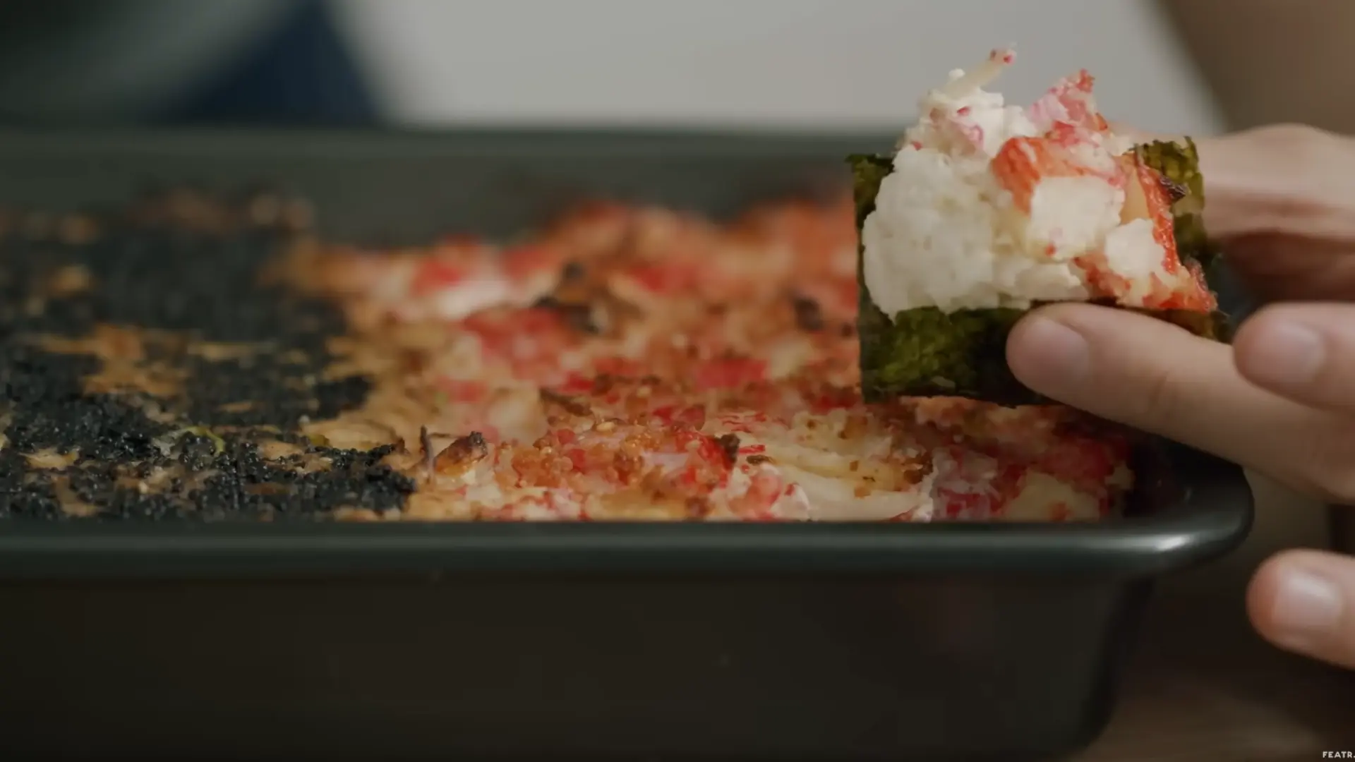 sliced baked sushi served with seaweed sheets for scooping warm creamy rice and seafood layers