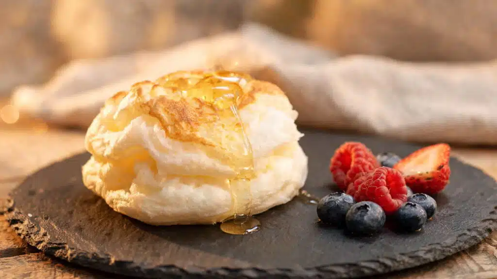 honey drizzled fluffy cloud bread with berries on slate plate close up warm tone (1)