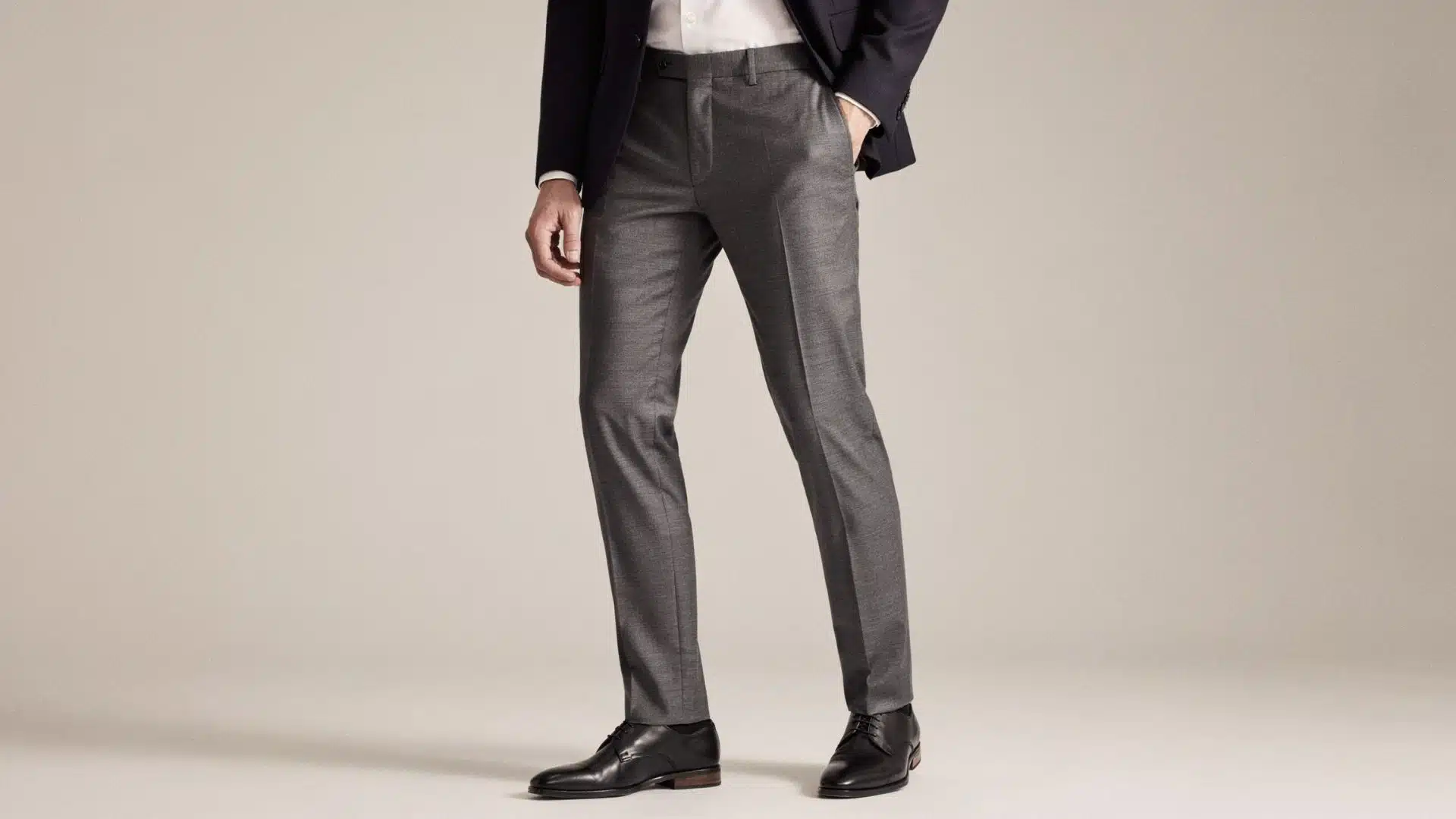 Man wearing tailored formal trousers with a blazer and dress shoes for a professional office-ready look.