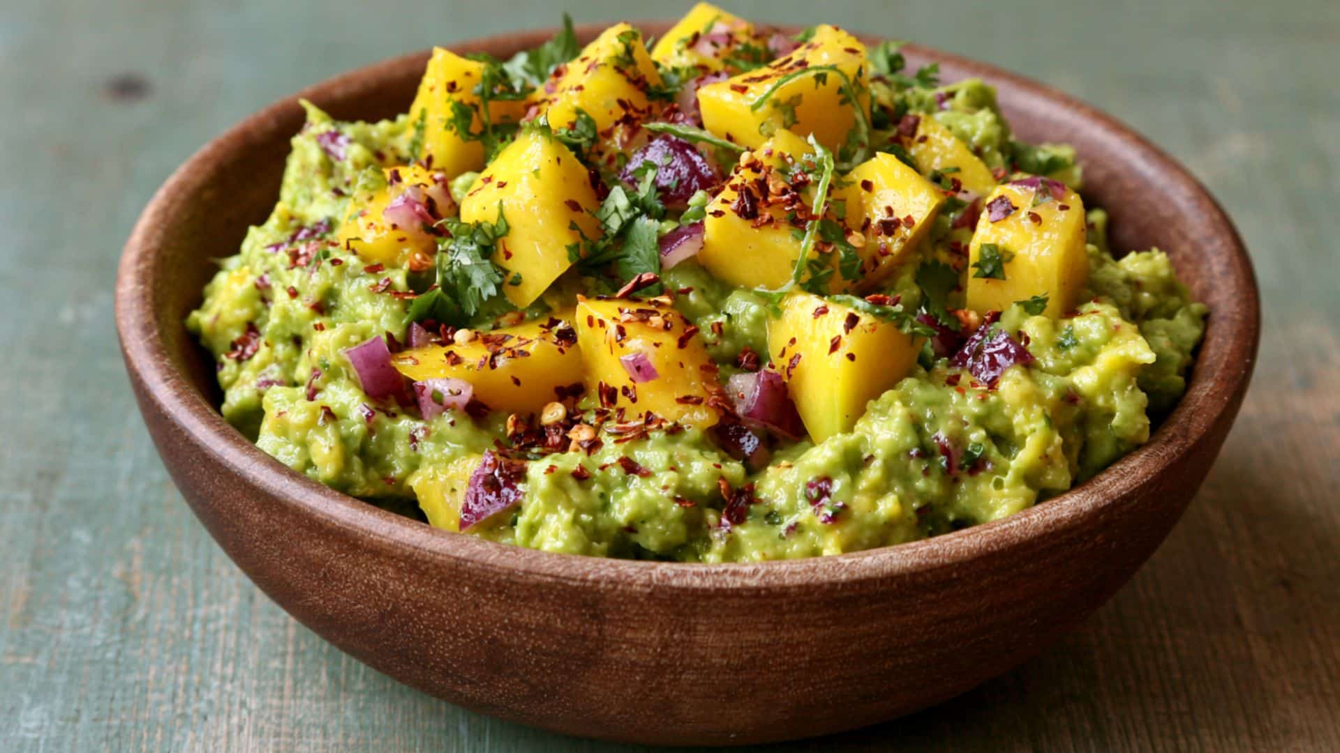 Mango guacamole topped with red onion and chili flakes