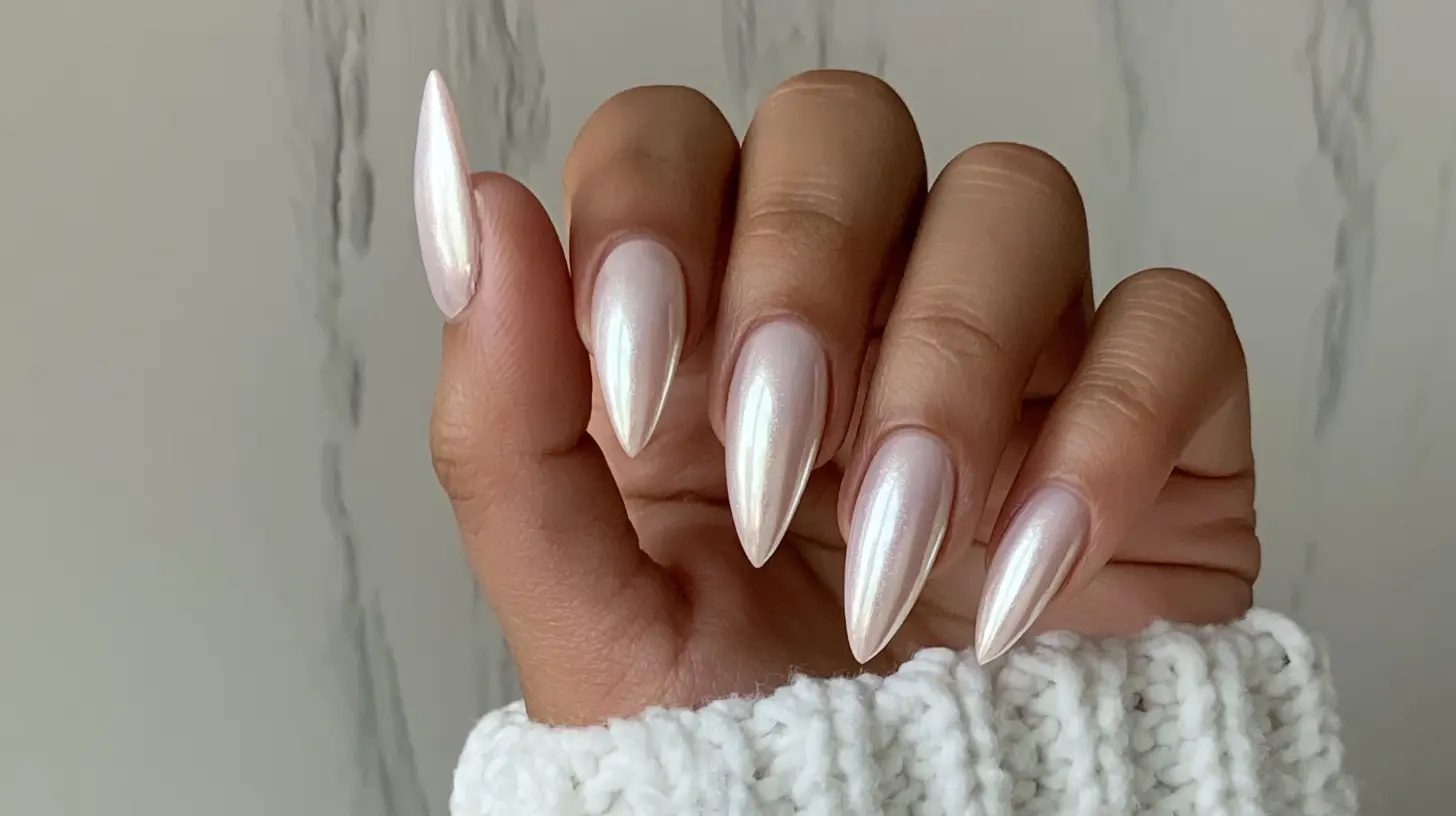 Long stiletto nails with a pearly iridescent white chrome finish.