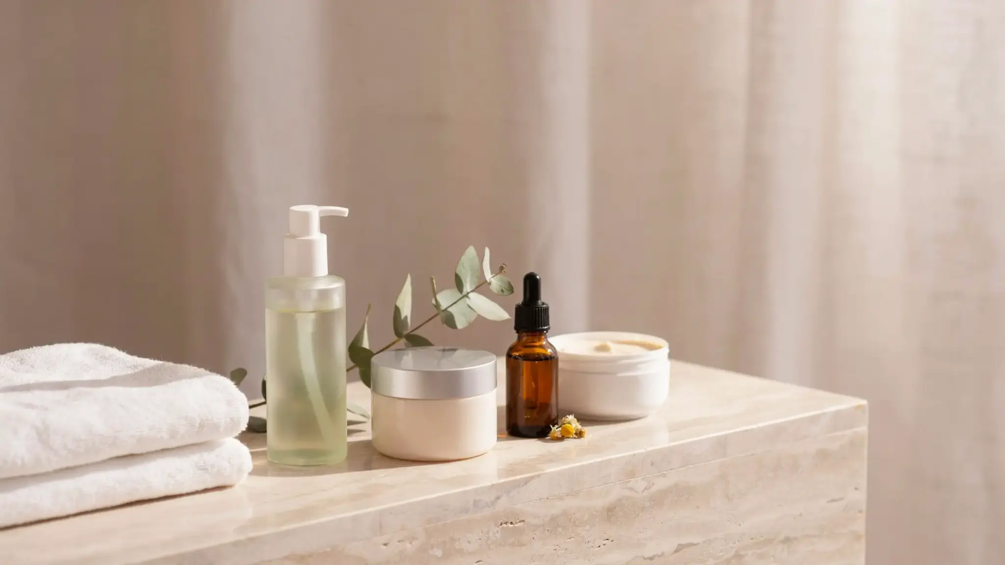 Bathroom shelf displaying aloe vera gel moisturizer chamomile product and ceramide cream for soothing skin care after waxing