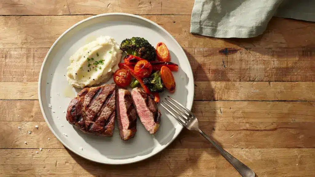 8 oz steak portion served on a plate with sides showing its typical dinner size