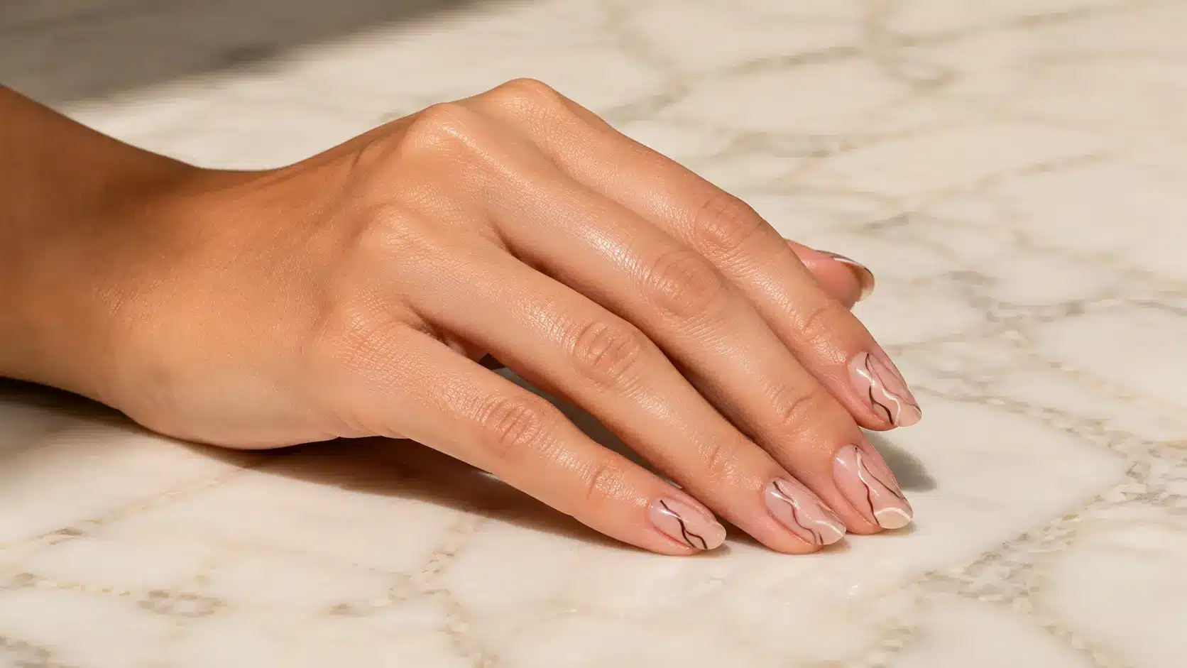 Wavy line art nail design featuring glossy nude nails with soft curved patterns for a simple nail art look